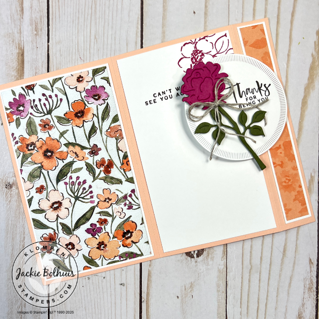 Handmade back fold card displayed flat, decorated with stamped flowers and layered die-cut details using Stampin’ Up! Charming Day and Spotlight on Nature dies.