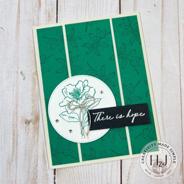 Card featuring a stamped background on cardstock cut to template measurements, with a small focal image created using Spotlight on Nature dies and a heat-embossed sentiment in the corner.