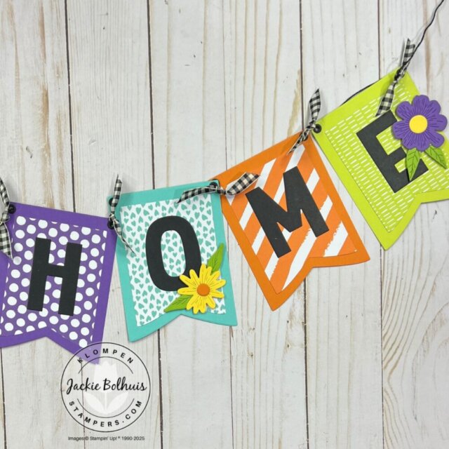 Custom handmade banner made with patterned paper and die-cut shapes.