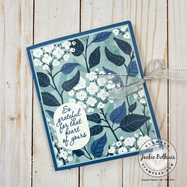 Front view of the completed card folio, featuring layered paper, stamped sentiment, and decorative elements.