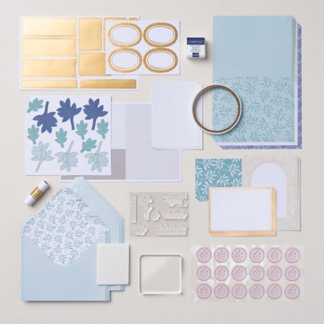 Flat lay of all components in the Everyday Beauty Kit, including the stamp set, ink spot, envelopes, metallic thread, precut pieces, and faux wax seals.