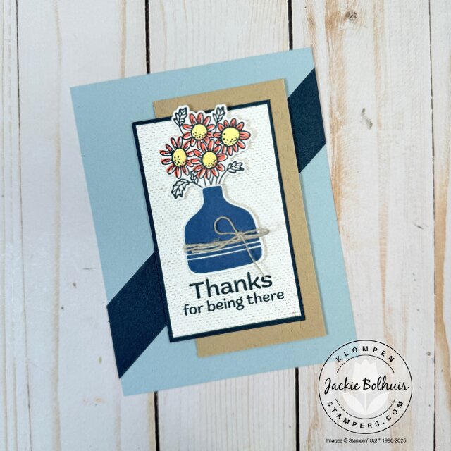 Card front layout showing patterned paper, stamped sentiment, and die cut flower embellishment.