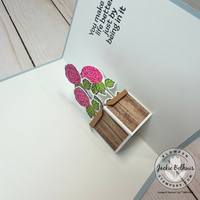 Interior pop-up card detail displaying layered petals and lifted flower design.