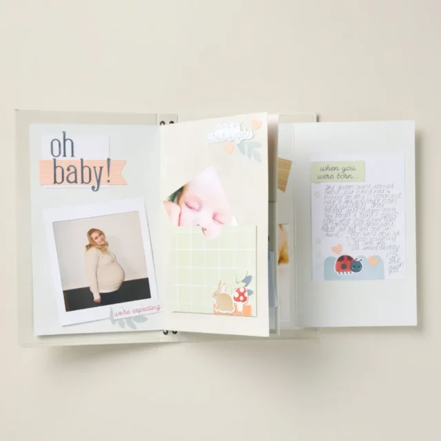 Completed baby album pages from the As You Grow Kit featuring milestone layouts and stickers.